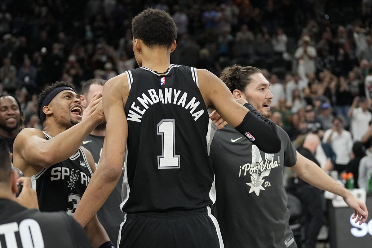 San Antonio Spurs forwards Victor Wembanyama (1) and Keldon Johnson (3) react after an overtime victory over the New York Knicks at Frost Bank Center. 