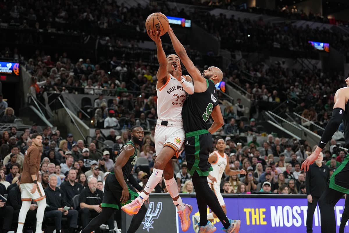 San Antonio Spurs guard Tre Jones (33) shoots against Boston Celtics guard Derrick White (9) in the second half at Frost Bank Center.