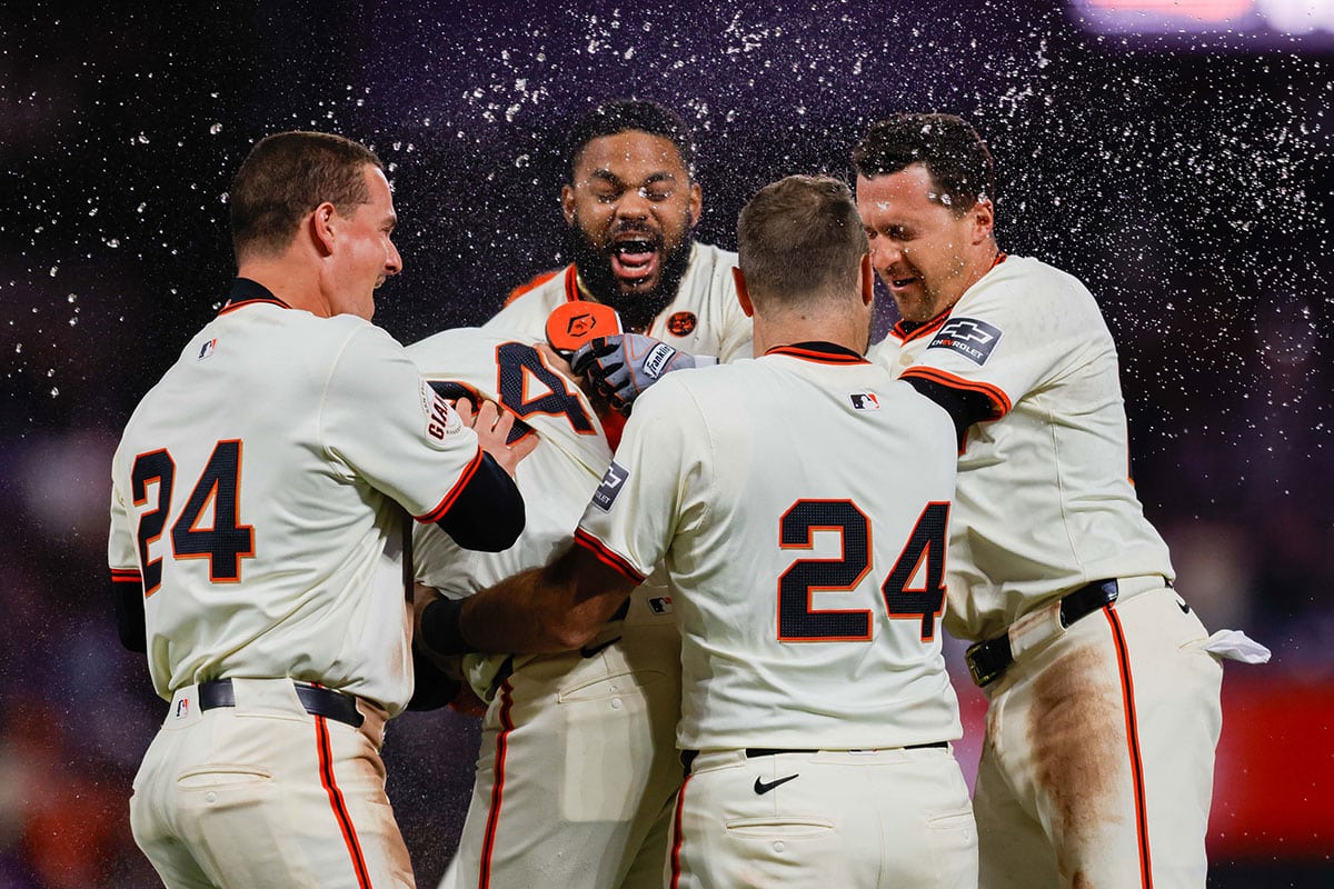 San Francisco Giants players celebrate after the game against the Chicago Cubs at Oracle Park. All Giants players wore the number 24 in honor of Giants former player Willie Mays.