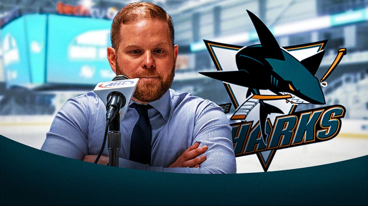 Ryan Warsofsky in a suit next to the San Jose Sharks logo