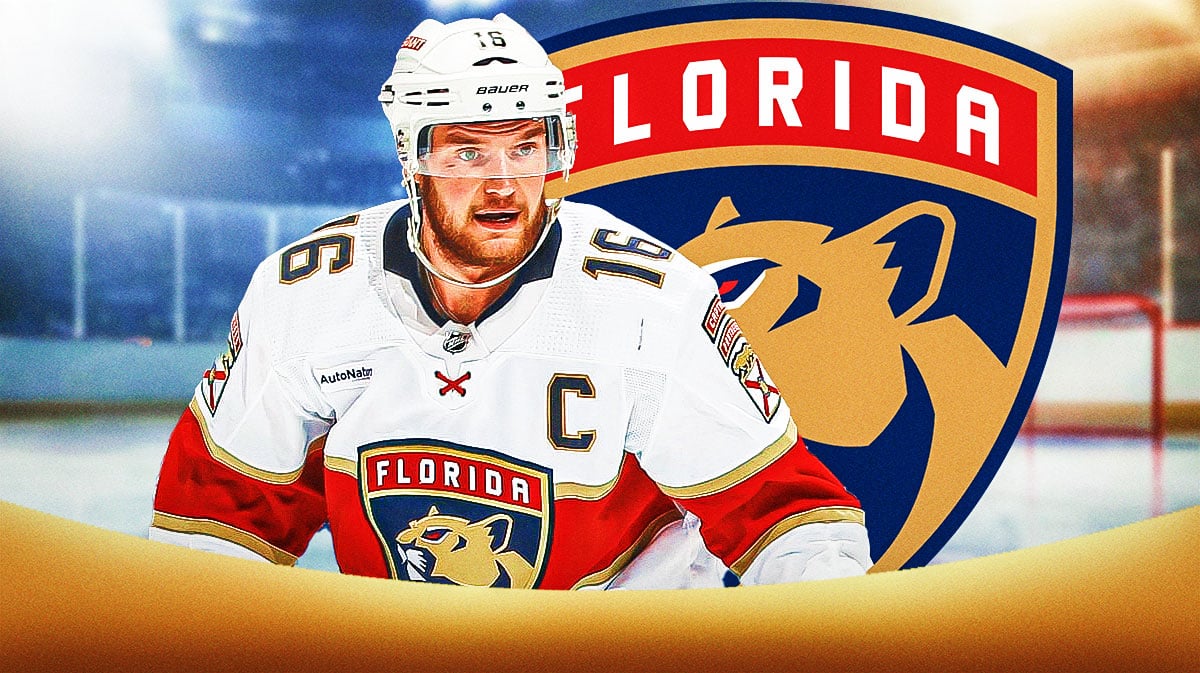 Sasha Barkov in middle of image looking stern, Florida Panthers logo, hockey rink in background