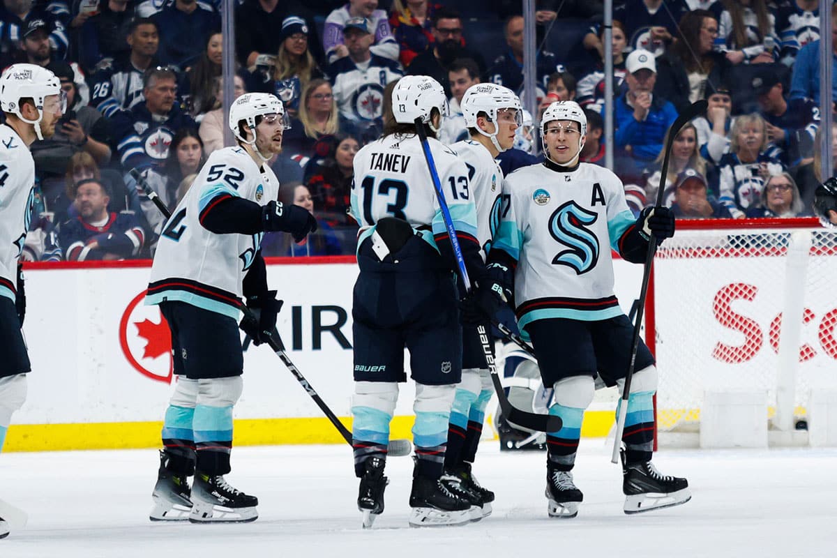 Seattle Kraken forward Yanni Gourde (37) is congratulated by teammates after a goal against the Winnipeg Jets during the second period at Canada Life Centre.
