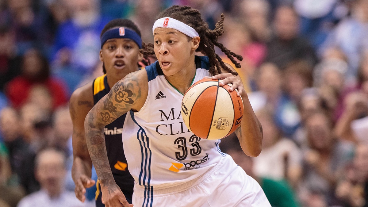 Seimone Augustus driving past a defender while playing for the Minnesota Lynx