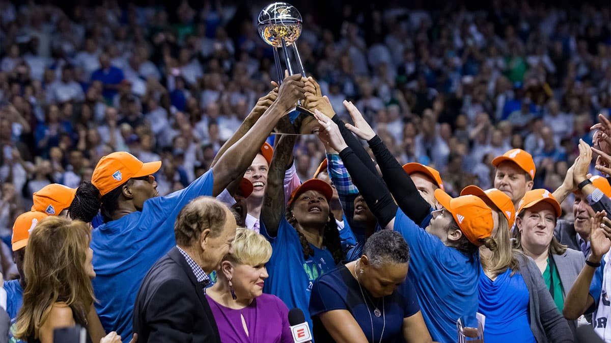 Minnesota Lynx guard Seimone Augustus (33) holds up the championship trophy after the game against the Los Angeles Sparks