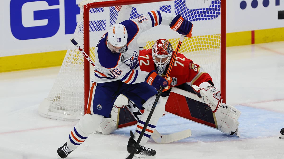 Edmonton Oilers forward Zach Hyman (18) tries to control the puck in front of Florida Panthers goaltender Sergei Bobrovsky (72) during the second period in game one of the 2024 Stanley Cup Final at Amerant Bank Arena.
