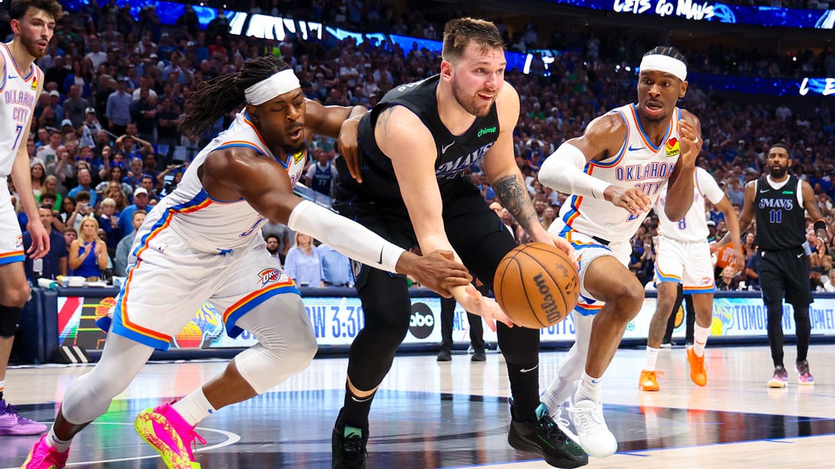 Dallas Mavericks guard Luka Doncic (77) passes the ball as Oklahoma City Thunder guard Luguentz Dort (5) and Oklahoma City Thunder guard Shai Gilgeous-Alexander (2) during the second half in game six of the second round of the 2024 NBA playoffs at American Airlines Center.