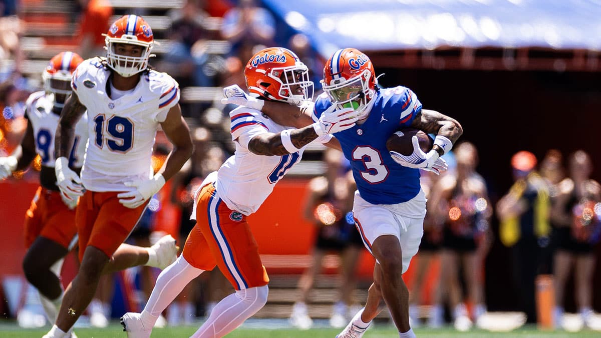 Florida Gators wide receiver Eugene Wilson III (3) stiff arms Florida Gators defensive back Sharif Denson (0) during the first half at the Orange and Blue spring football game at Steve Spurrier Field at Ben Hill Griffin Stadium