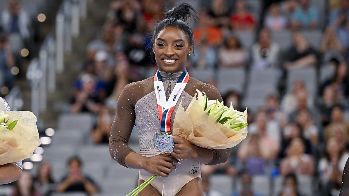 Simone Biles of World Champions Centre poses for a photo with her gold medal and commemorative belt buckle after finishing in first in the women’s 2024 Xfinity U.S. Gymnastics Championships.