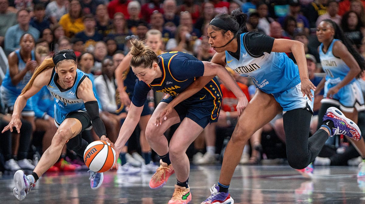 Indiana Fever forward Katie Lou Samuelson (33) reaches for a loose ball while being guarded by Chicago Sky forward Angel Reese (5) 
