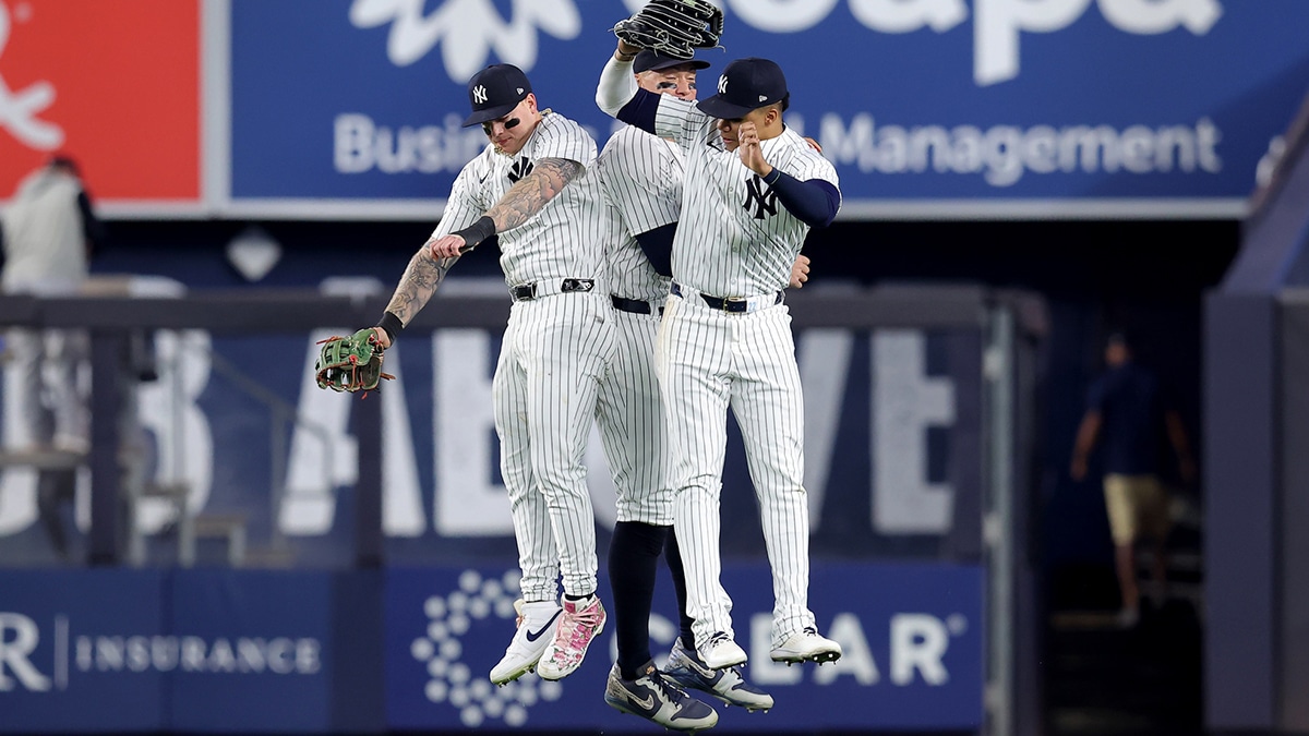 New York Yankees left fielder Alex Verdugo (24) and center fielder Aaron Judge (99) and right fielder Juan Soto (22) celebrate after defeating the Minnesota Twins at Yankee Stadium.