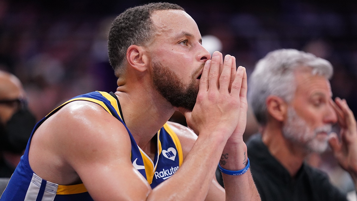 Golden State Warriors guard Stephen Curry (30) sits on the bench during action against the Sacramento Kings in the fourth quarter during a play-in game of the 2024 NBA playoffs at the Golden 1 Center.