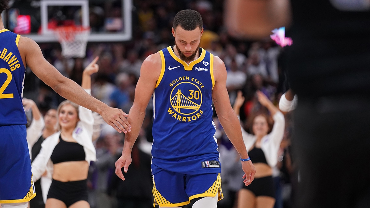 Golden State Warriors guard Stephen Curry (30) walks towards the team bench during a timeout against the Sacramento Kings in the fourth quarter during a play-in game of the 2024 NBA playoffs at the Golden 1 Center.
