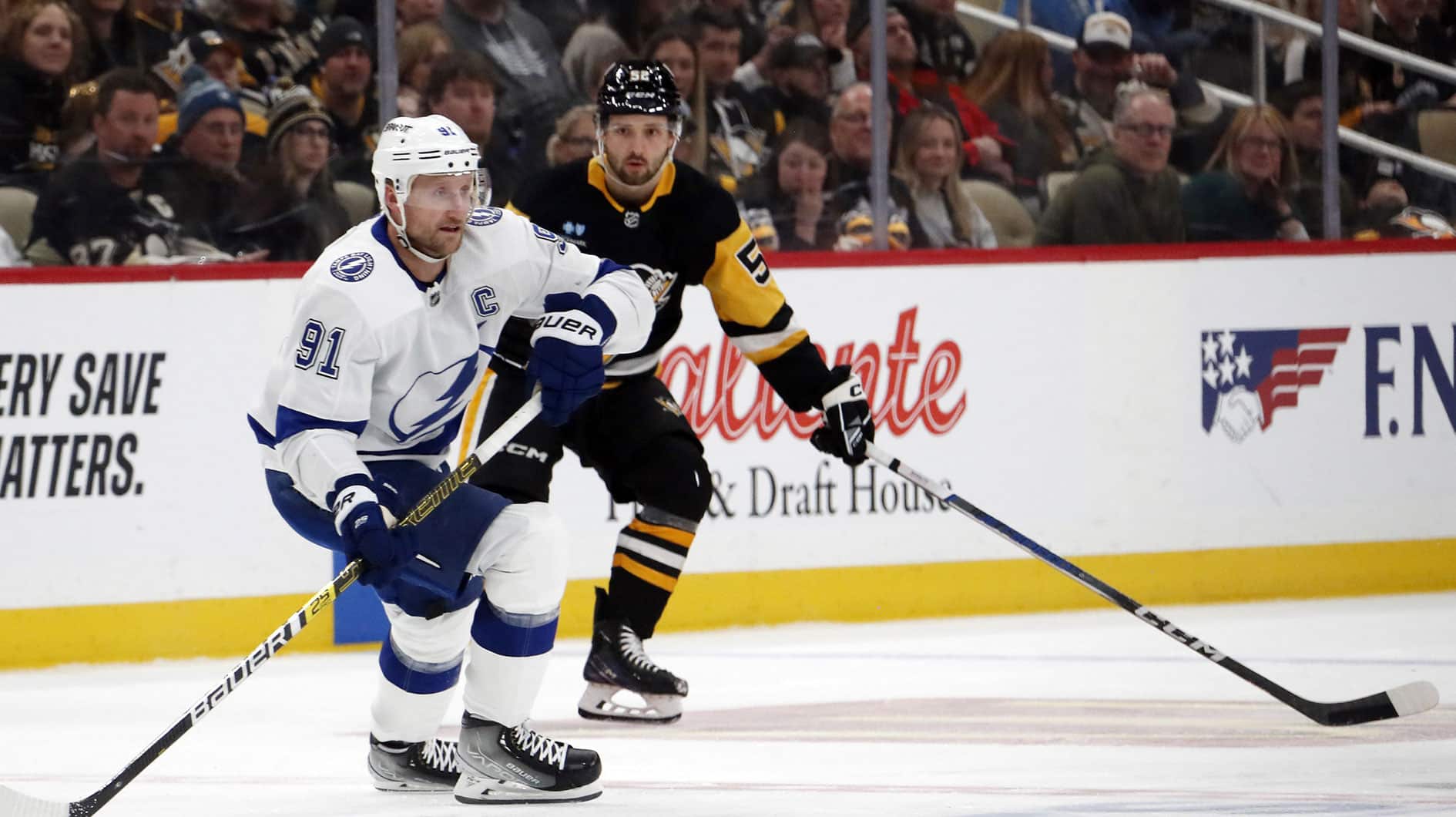 Tampa Bay Lightning center Steven Stamkos (91) handles the puck ahead of Pittsburgh Penguins center Emil Bemstrom (52) during the second period at PPG Paints Arena. The Penguins won 5-4. 