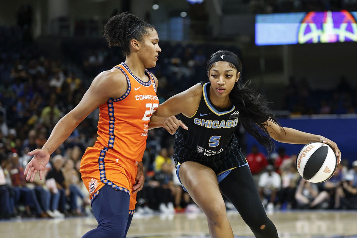 Chicago Sky forward Angel Reese (5) goes to the basket against Connecticut Sun forward Alyssa Thomas (25) during the second half of a basketball game.