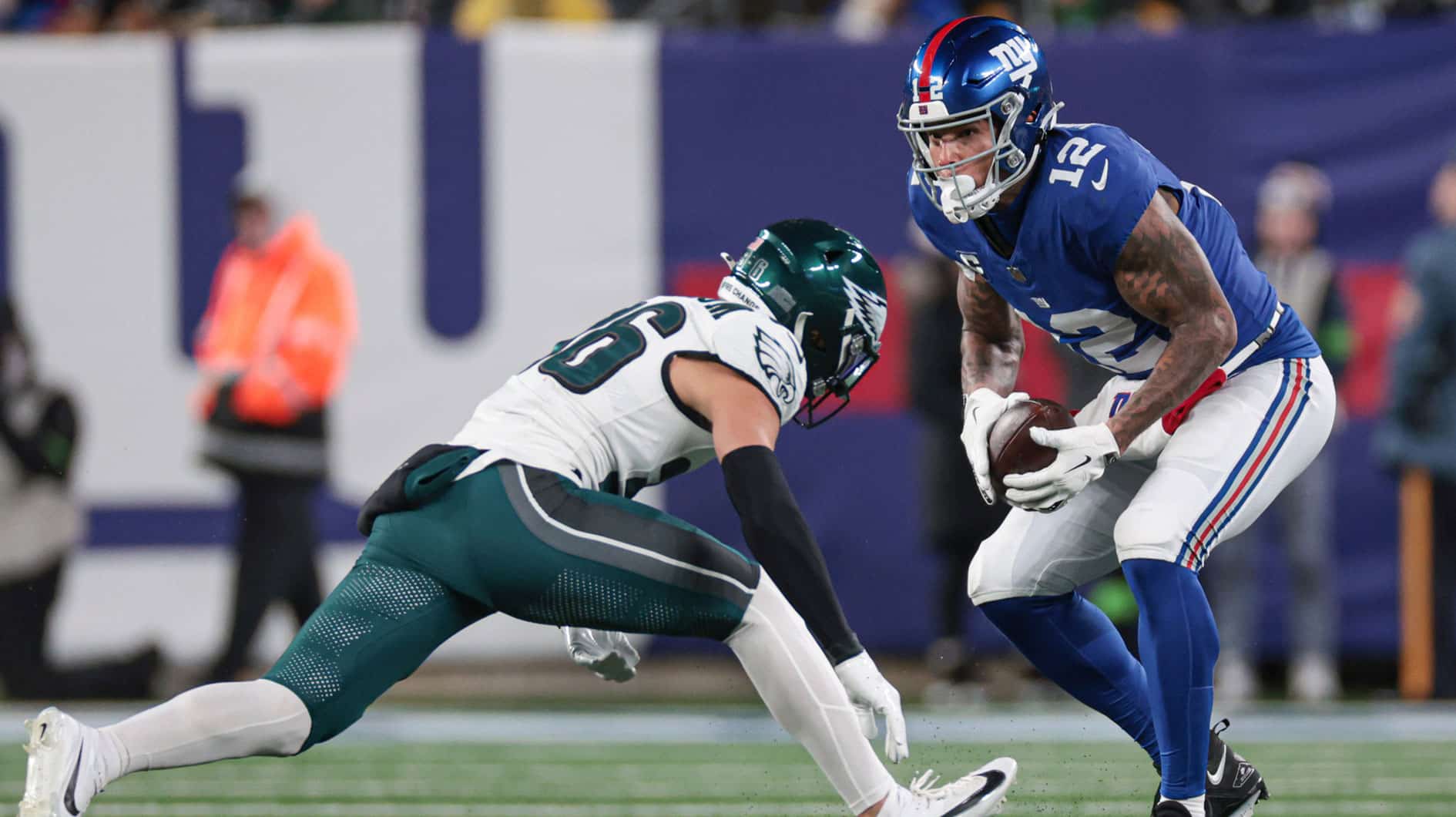 New York Giants tight end Darren Waller (12) makes a catch in front of Philadelphia Eagles safety Tristin McCollum (36) during the second half at MetLife Stadium. 