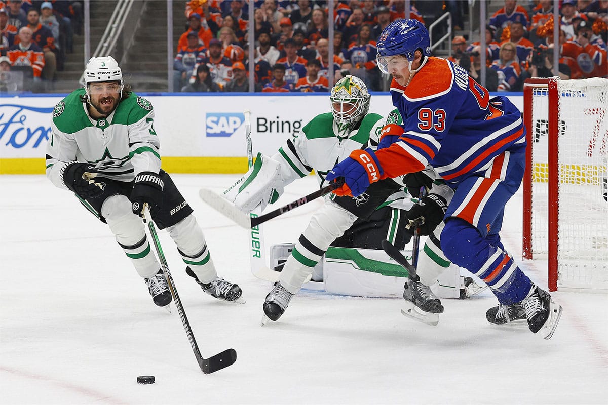 Dallas Stars defensemen Chris Tanev (3) and Edmonton Oilers forward Ryan Nugent-Hopkins (93) chase a loose puck during the first period in game three of the Western Conference Final of the 2024 Stanley Cup Playoffs at Rogers Place