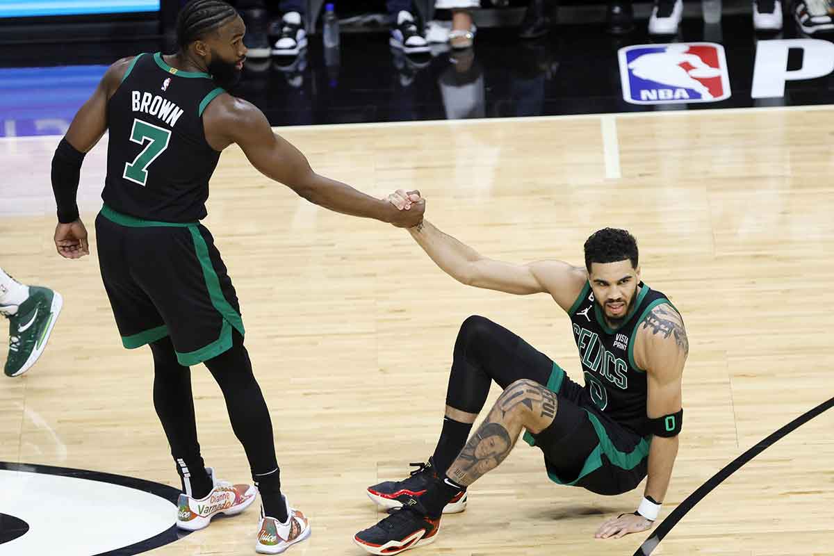Boston Celtics guard Jaylen Brown (7) helps up forward Jayson Tatum (0) during the first half against the Miami Heat in game three of the Eastern Conference Finals for the 2023 NBA playoffs at Kaseya Center.