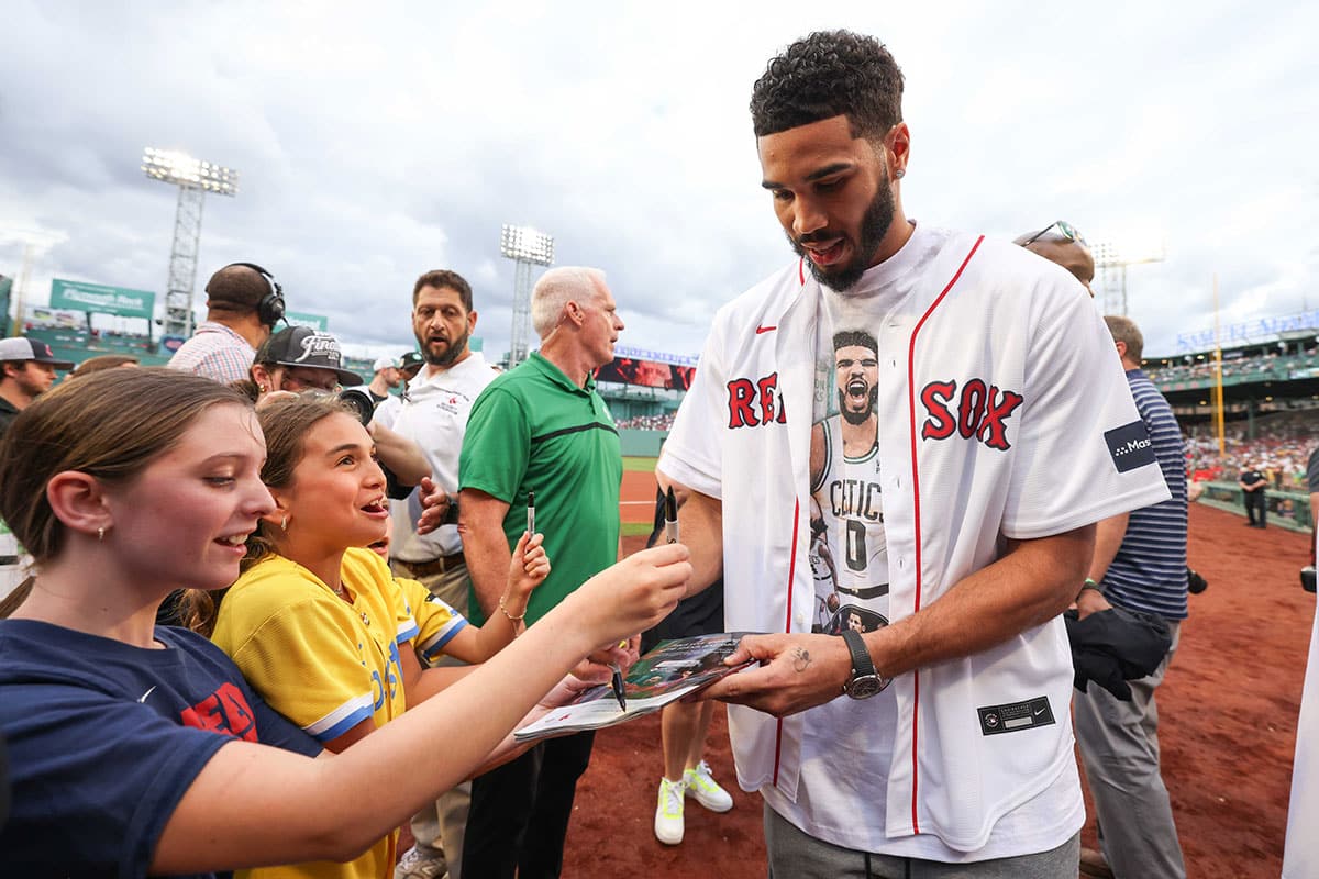 Boston Celtics forward Jayson Tatum (0) signs his autograph before a game between the Toronto Blue Jays and the Boston Red Sox at Fenway Park