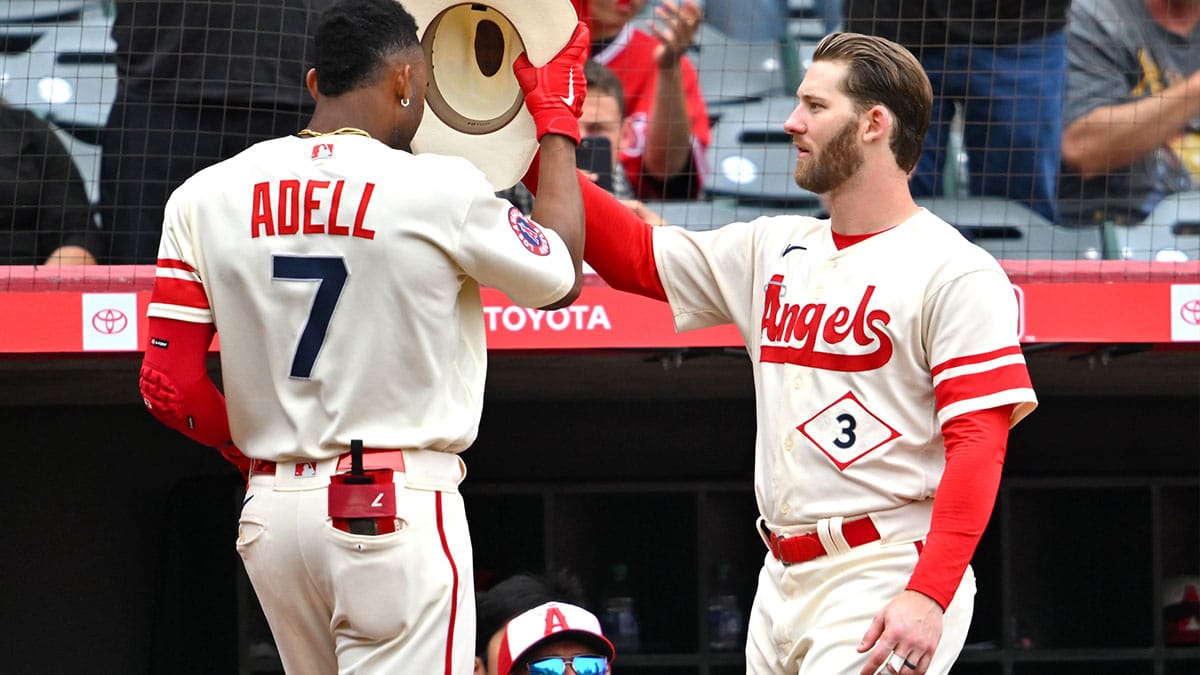 Los Angeles Angels left fielder Jo Adell (7) is met by right fielder Taylor Ward (3) at the dugout after hitting a solo home run in the fourth inning against the Oakland Athletics at Angel Stadium.
