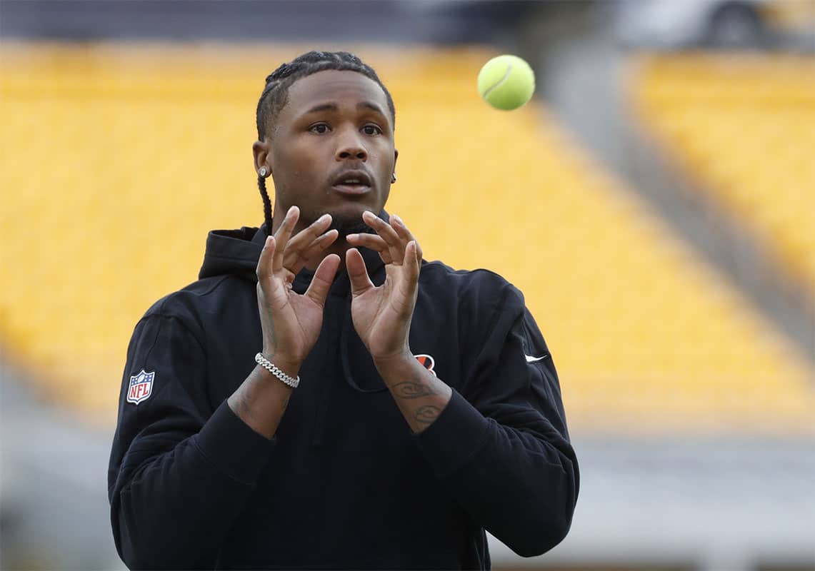 Cincinnati Bengals wide receiver Tee Higgins (5) warms up with tennis balls before the game against the Pittsburgh Steelers at Acrisure Stadium.