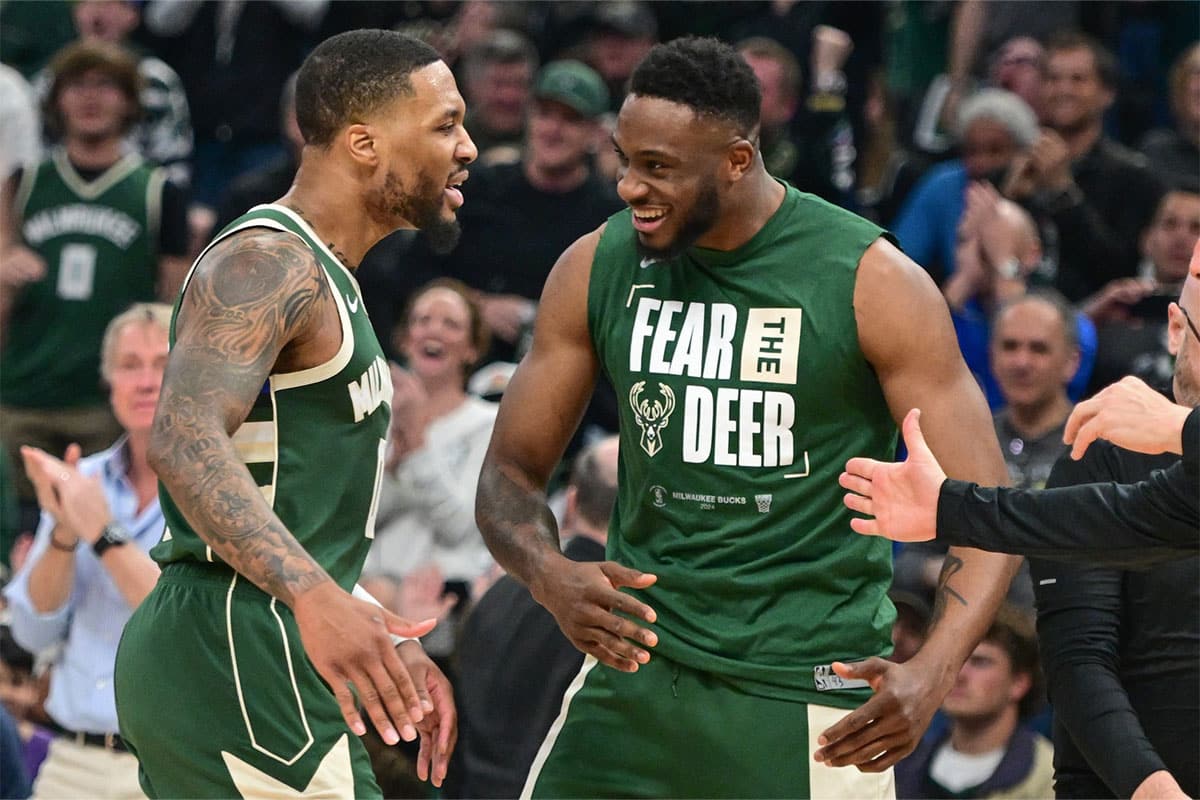 Milwaukee Bucks guard Damian Lillard (0) is greeted by forward Thanasis Antetokounmpo (43) after a timeout in the second quarter against the Indiana Pacers during game one of the first round for the 2024 NBA playoffs at Fiserv Forum.