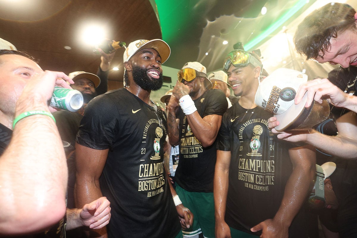  Boston Celtics guard Jaylen Brown (left) celebrates in the locker room after winning the 2024 NBA Finals against the Dallas Mavericks at TD Garden.
