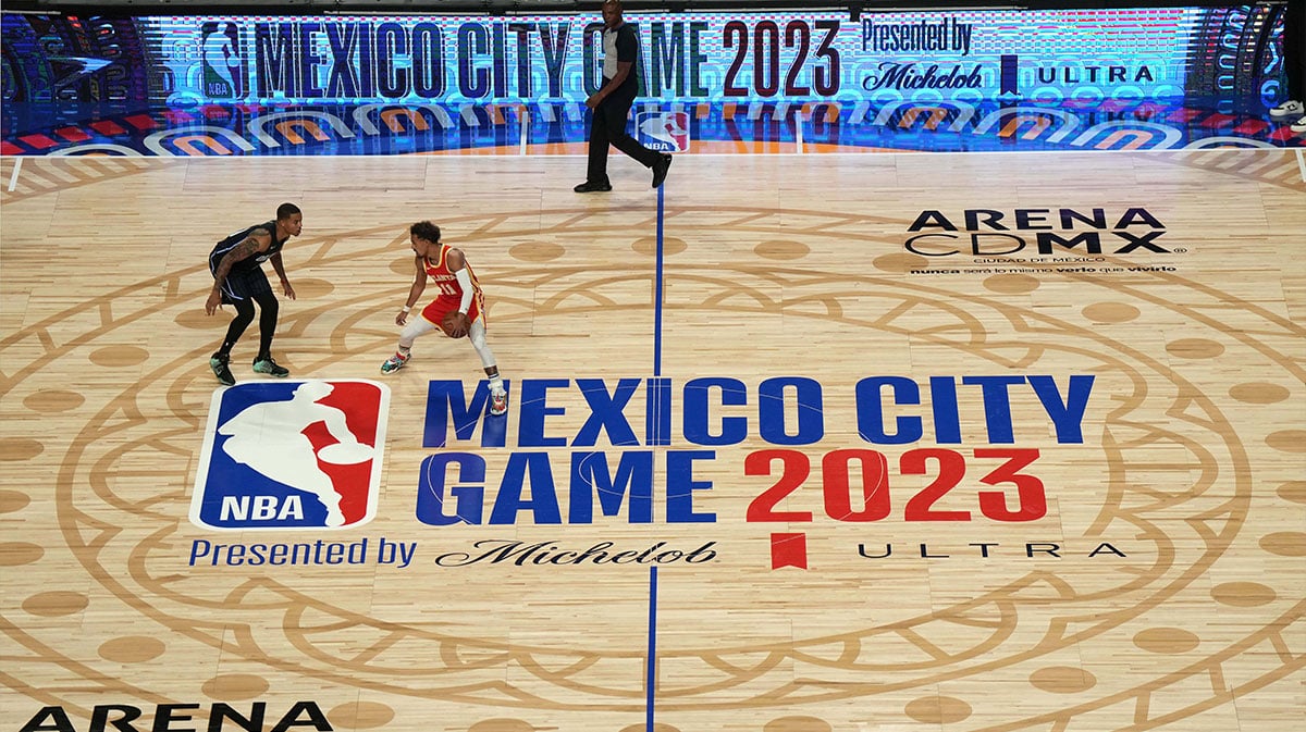Atlanta Hawks guard Trae Young (11) dribbles the ball against Orlando Magic guard Markelle Fultz (20) at center court on the 2023 NBA Mexico City Game logo at the Arena CDMX.