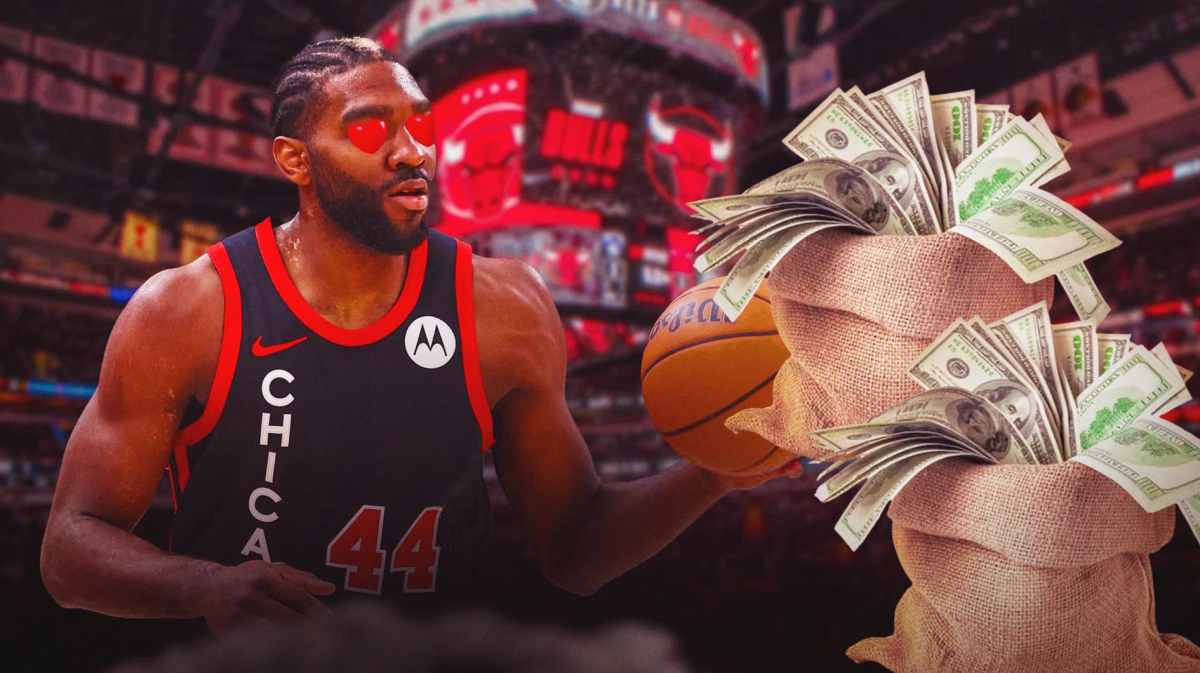 Patrick Williams looks at a bag of money with heart eyes