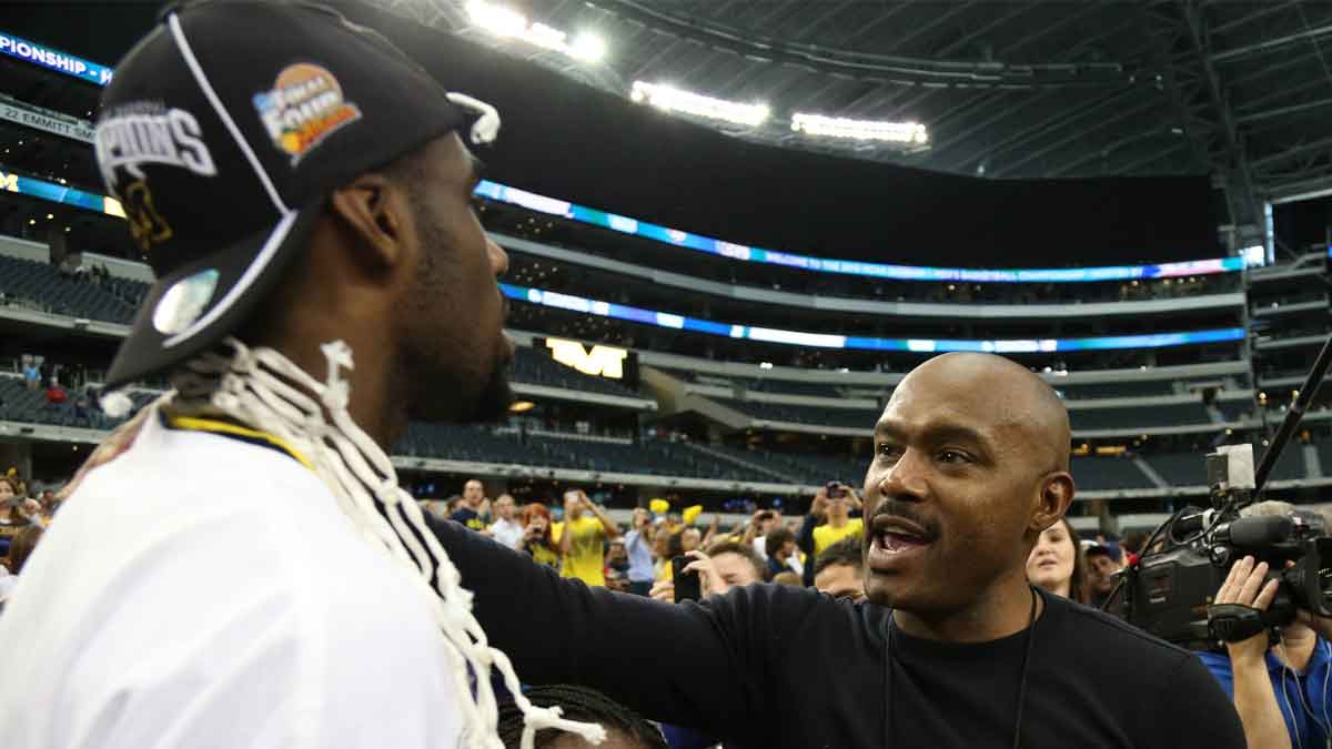 Tim Hardaway Sr. congratulates his son Michigan Wolverines guard Tim Hardaway Jr. (left) after defeating the Florida Gators 79-59 in the South regional final of the 2013 NCAA Tournament at Cowboys Stadium