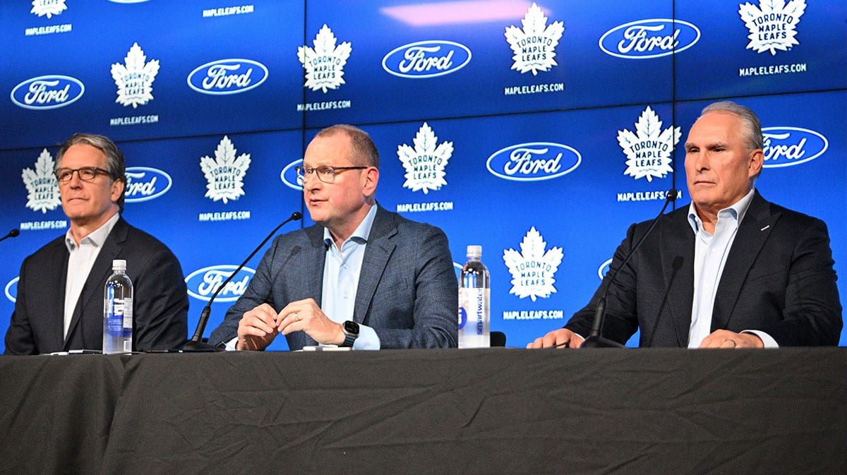 Toronto Maple Leafs general manager Brad Treliving (center) and team president Brendan Shanahan (left) introduce new head coach Craig Berube at Ford Performance Centre.