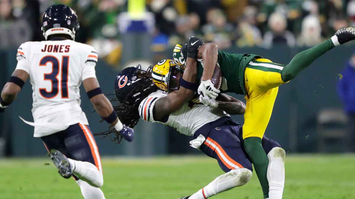 Chicago Bears linebacker Tremaine Edmunds (49) tackles Green Bay Packers wide receiver Bo Melton (80) during their football game Sunday, January 7, 2024, in Green Bay, Wisconsin