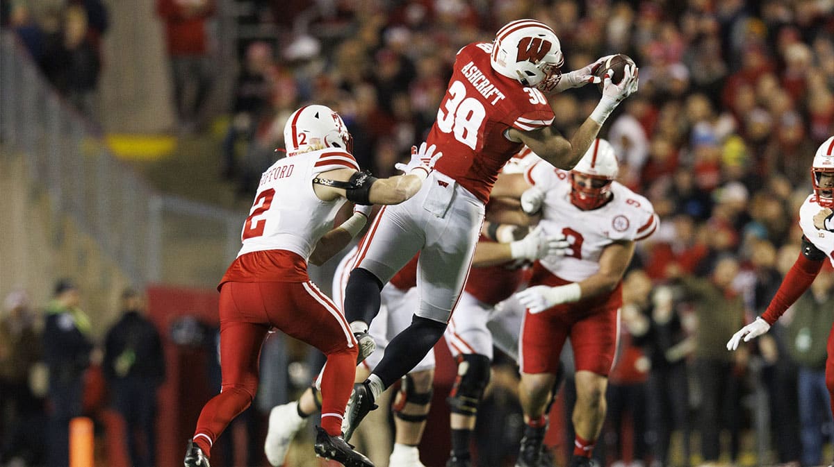 Wisconsin Badgers tight end Tucker Ashcraft (38) catches a pass in front of Nebraska Cornhuskers defensive back Isaac Gifford (2) during the second quarter at Camp Randall Stadium.