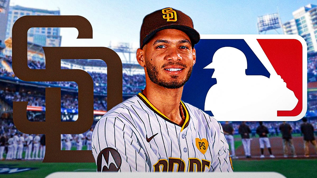 Tucupita Marcano in middle of image looking stern, San Diego Padres and MLB logo, baseball field in background.
