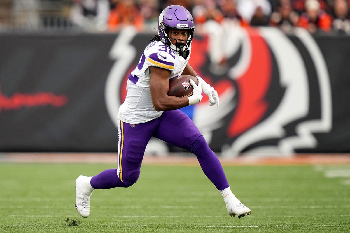 Minnesota Vikings running back Ty Chandler (32) carries the ball in the third quarter of a Week 15 NFL football game between the Minnesota Vikings and the Cincinnati Bengals, Saturday, Dec. 16, 2023, at Paycor Stadium in Cincinnati. The Cincinnati Bengals won 27-24 in overtime.