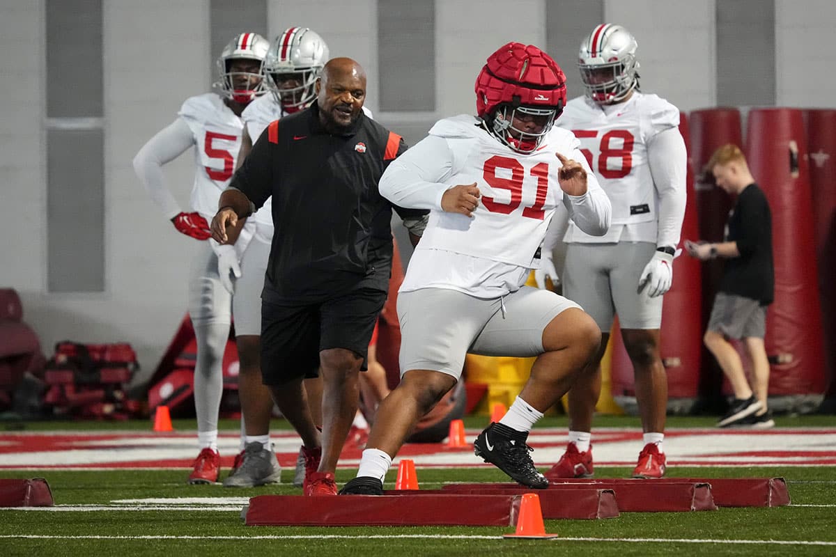 Defensive line coach Larry Johnson watches as defensive lineman Tyleik Williams (91) runs during the first spring practice at the Woody Hayes Athletic Center.
