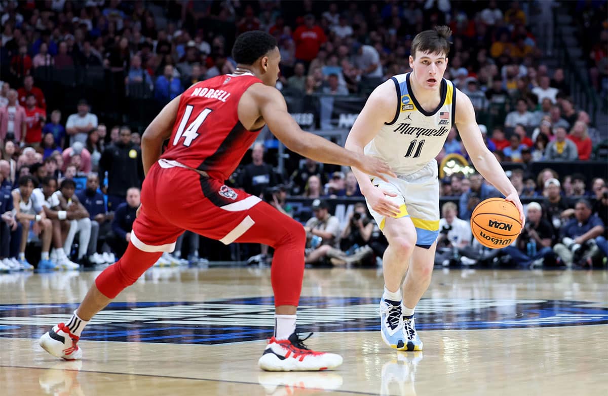 Marquette Golden Eagles guard Tyler Kolek (11) dribbles against North Carolina State Wolfpack guard Casey Morsell (14) during the first half in the semifinals of the South Regional of the 2024 NCAA Tournament at American Airlines Center. 