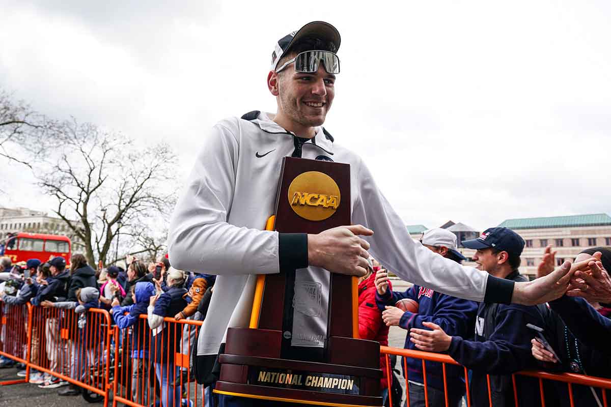UConn Huskies center Donovan Clingan (32) hold the championship trophy as he arrives at the State Capitol and greeted by fans before teams victory parade.