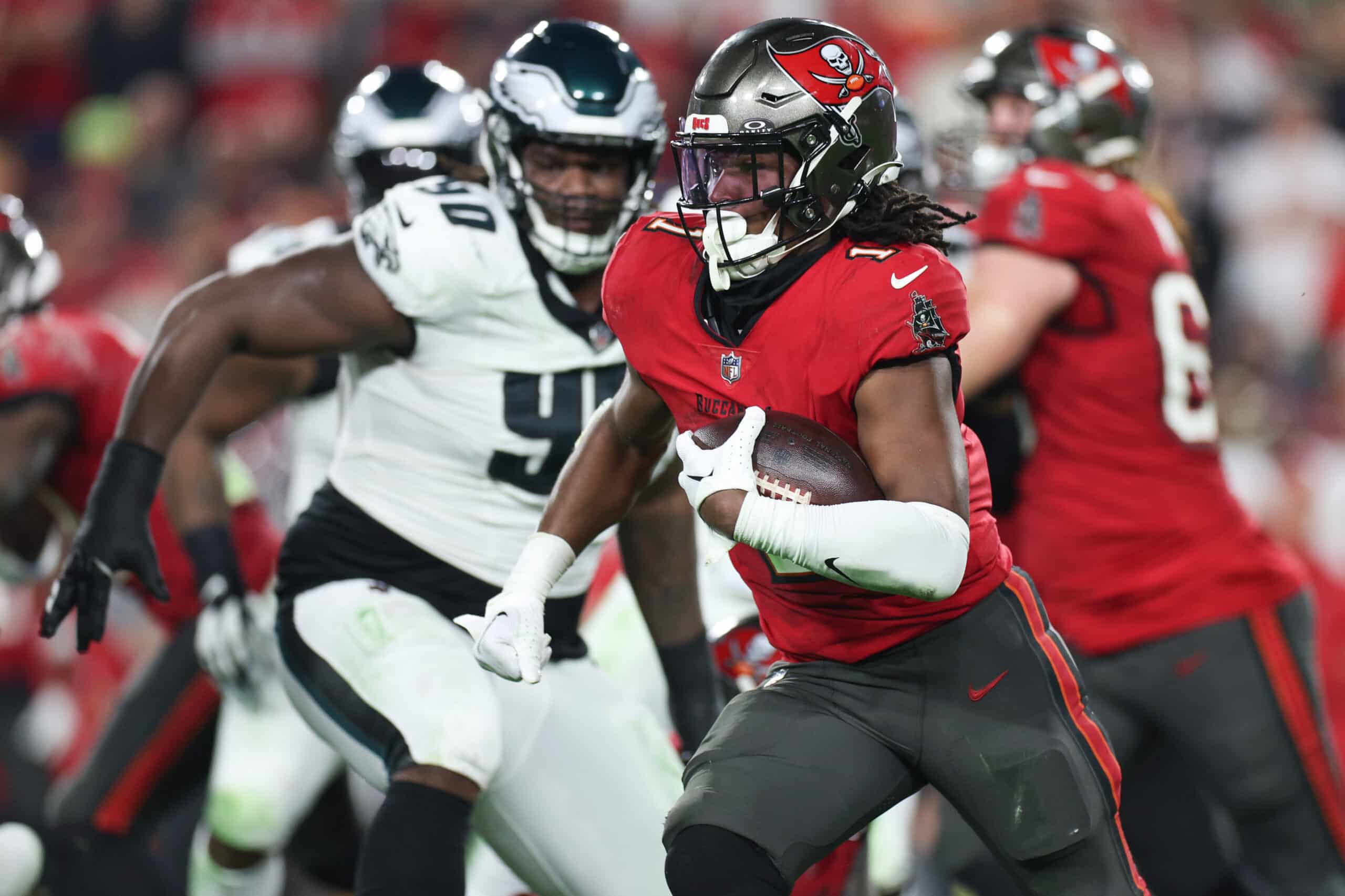Jan 15, 2024; Tampa, Florida, USA; Tampa Bay Buccaneers running back Rachaad White (1) runs the ball against the Philadelphia Eagles during the first half of a 2024 NFC wild card game at Raymond James Stadium. 