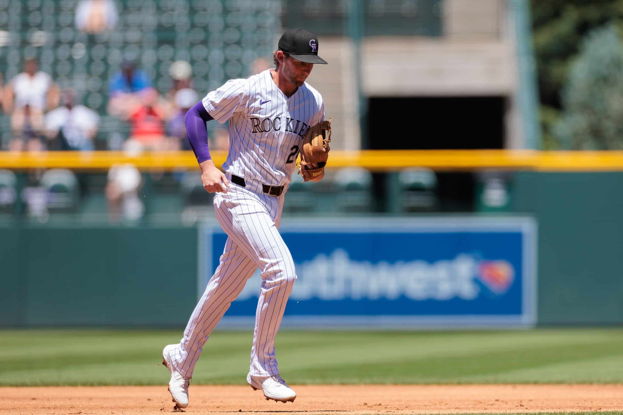 Jun 5, 2024; Denver, Colorado, USA; Colorado Rockies third base Ryan McMahon (24) runs to the dugout after catching a fly ball for an out during the first inning against the Cincinnati Reds at Coors Field.