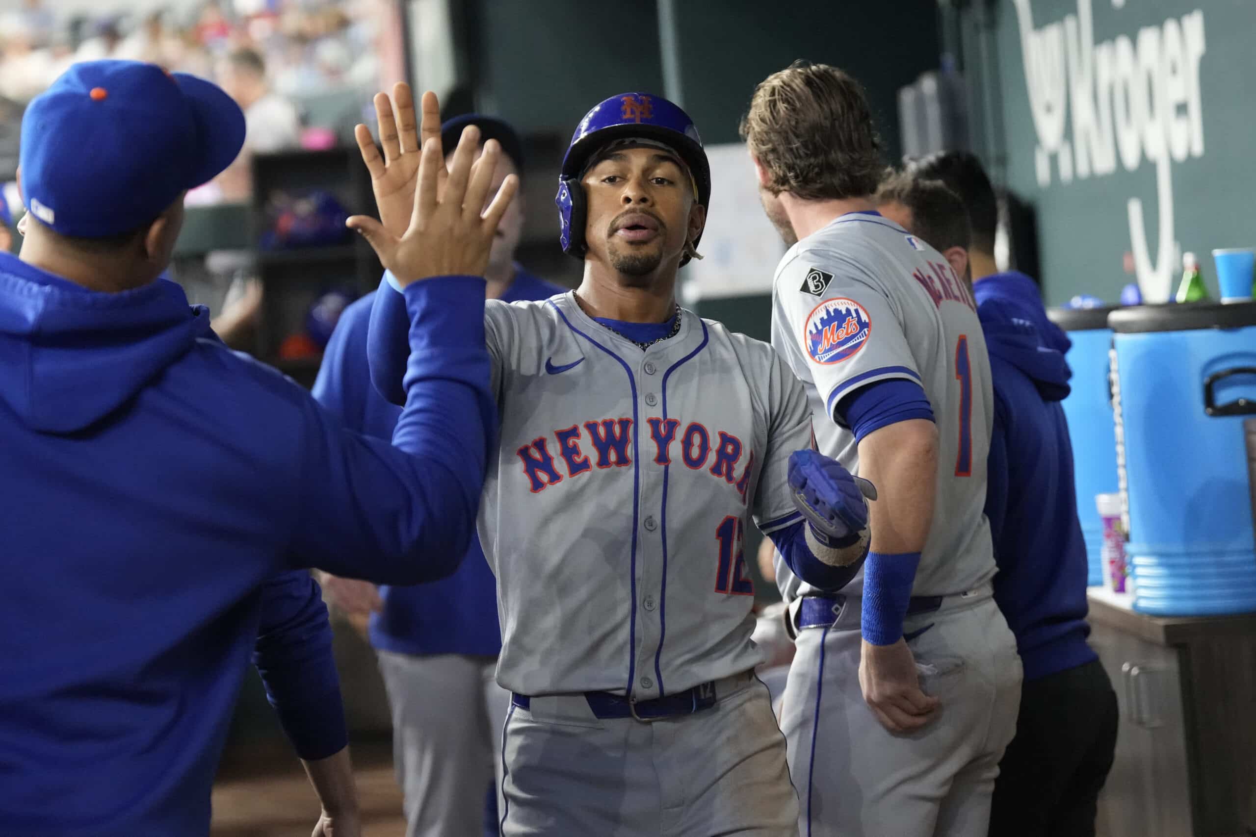 Jun 17, 2024; Arlington, Texas, USA; New York Mets shortstop Francisco Lindor (12) celebrates his run scored with teammates in the dugout during the first inning against the Texas Rangers at Globe Life Field. 