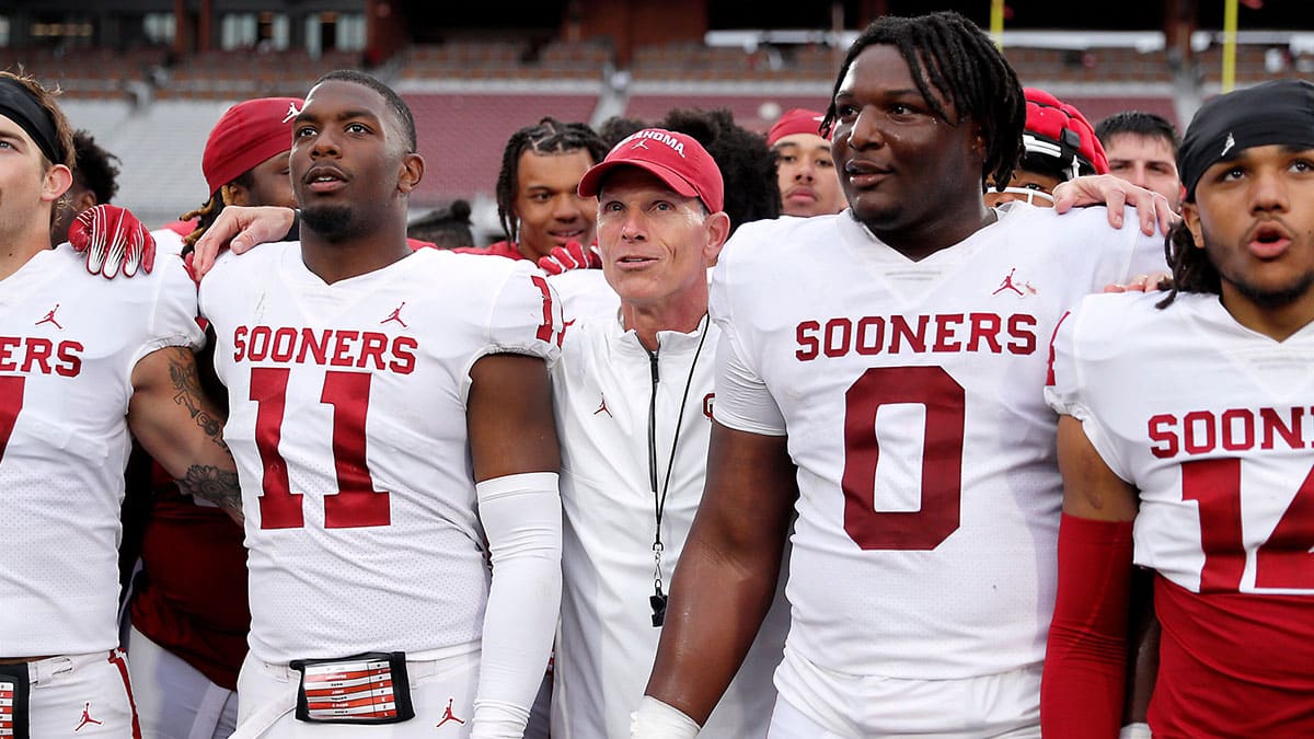 Oklahoma coach Brent Venables stands beside Kobie McKinzie (11) and David Stone (0) after a University of Oklahoma (OU) Sooners spring football game at Gaylord Family-Oklahoma Memorial Stadium in Norman, Okla., Saturday, April 20, 2024.