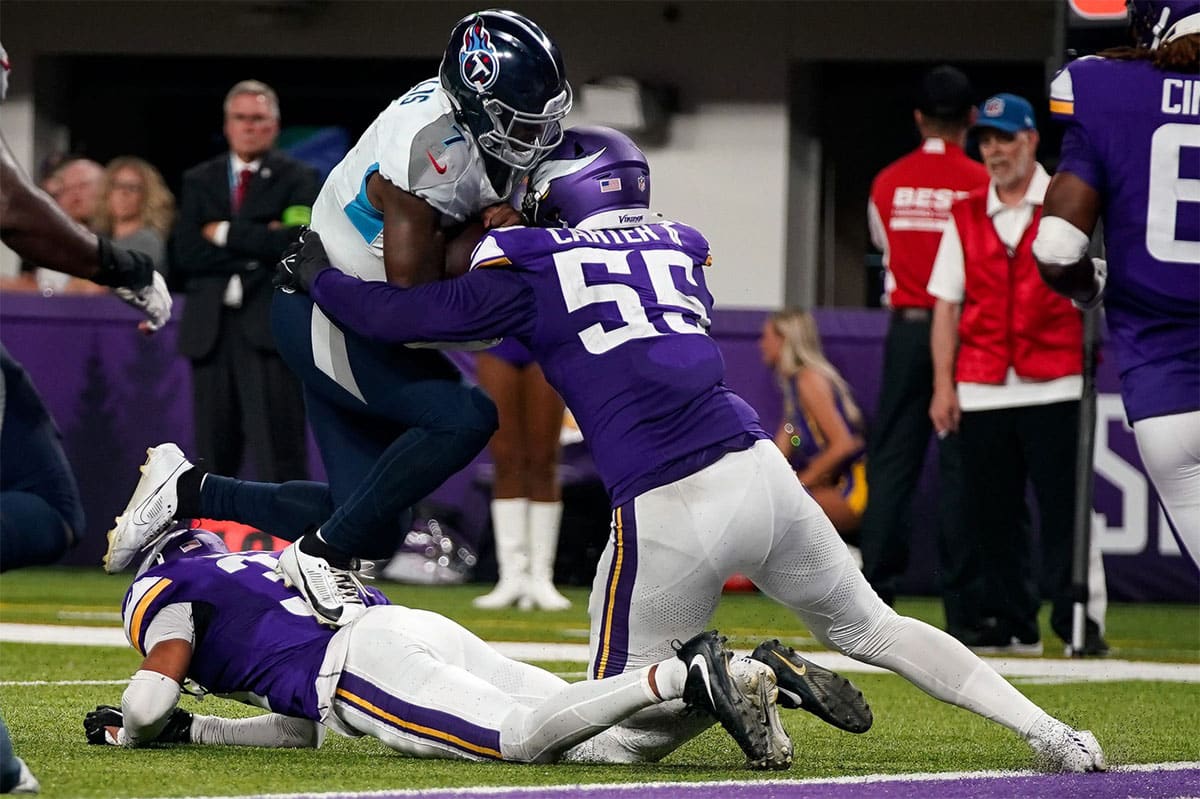 Tennessee Titans quarterback Malik Willis (7) is stopped short of the end zone by Minnesota Vikings linebacker Andre Carter II (55) during the fourth quarter at U.S. Bank Stadium in Minneapolis, Minn., Saturday, Aug. 19, 2023.