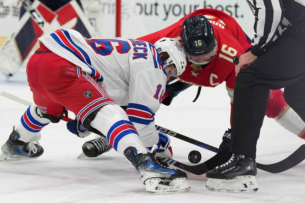 Florida Panthers center Aleksander Barkov (16) and New York Rangers center Vincent Trocheck (16) battle for possession during a face-off during the first period in game six of the Eastern Conference Final of the 2024 Stanley Cup Playoffs at Amerant Bank Arena.