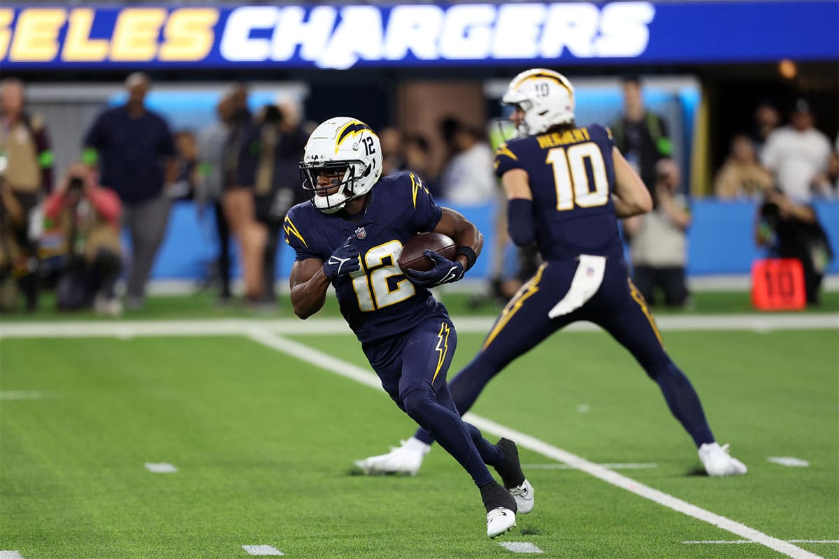 Los Angeles Chargers wide receiver Derius Davis (12) runs with a ball during the first quarter against the Baltimore Ravens at SoFi Stadium. 