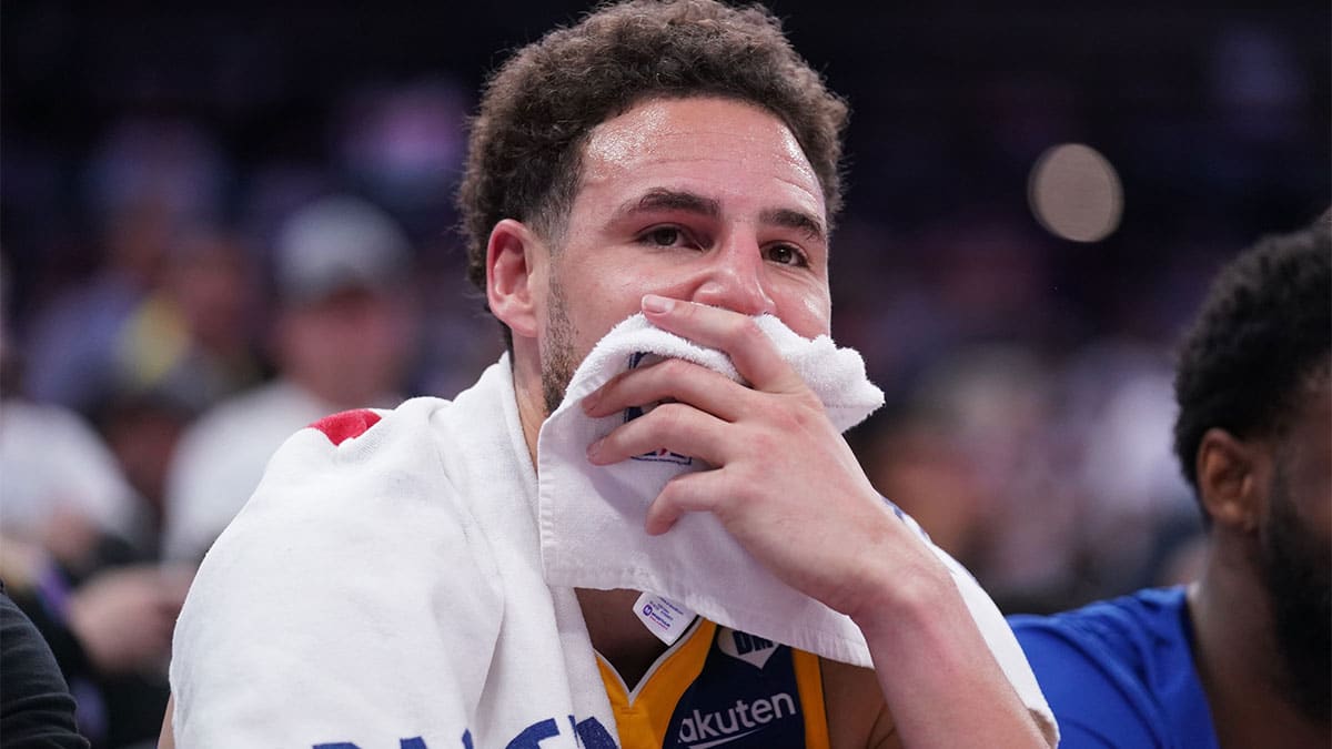 Golden State Warriors guard Klay Thompson (11) sits on the bench during action against the Sacramento Kings in the fourth quarter during a play-in game of the 2024 NBA playoffs at the Golden 1 Center
