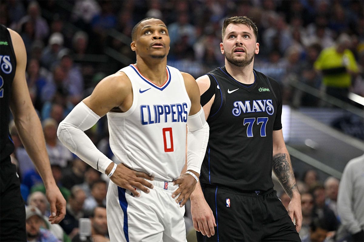  LA Clippers guard Russell Westbrook (0) and Dallas Mavericks guard Luka Doncic (77) look for the ball on a foul shot during the first quarter during game six of the first round for the 2024 NBA playoffs at American Airlines Center.