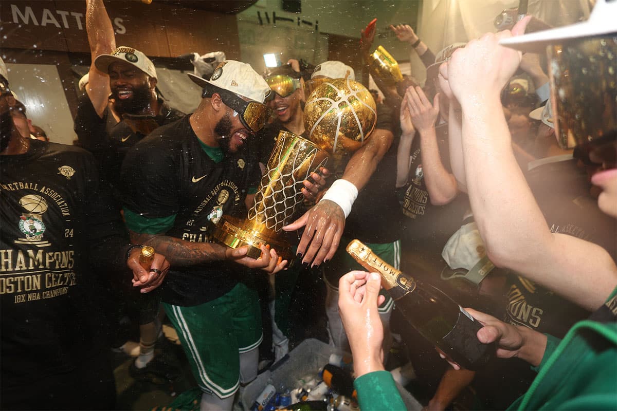 Xavier Tillman with Larry O'Brien trophy after winning championship with Celtics
