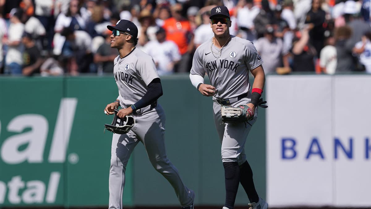 New York Yankees right fielder Juan Soto (left) and center fielder Aaron Judge (right) jog off the field after defeating the San Francisco Giants at Oracle Park.