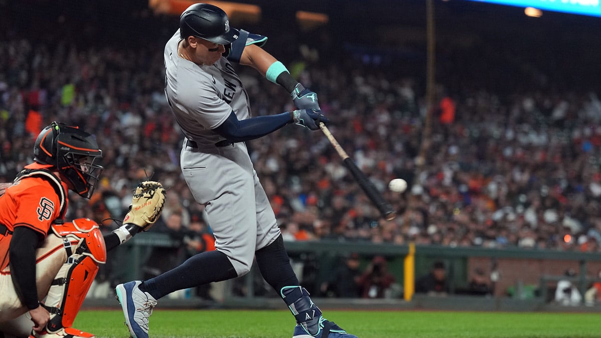 New York Yankees designated hitter Aaron Judge (center) hits a home run against the San Francisco Giants during the sixth inning at Oracle Park.