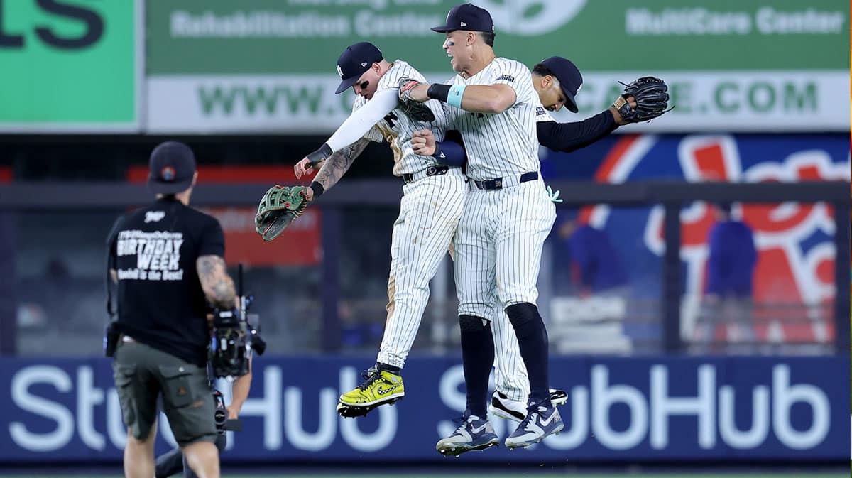 New York Yankees left fielder Alex Verdugo (24) and center fielder Aaron Judge (99) and right fielder Juan Soto (22) celebrates after the game against the Minnesota Twins at Yankee Stadium.